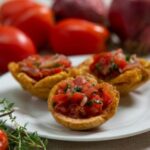 Fried plantain cups topped with fresh tomato and onion salsa — Haitian appetizer at AbondiZ in Chelsea, MA